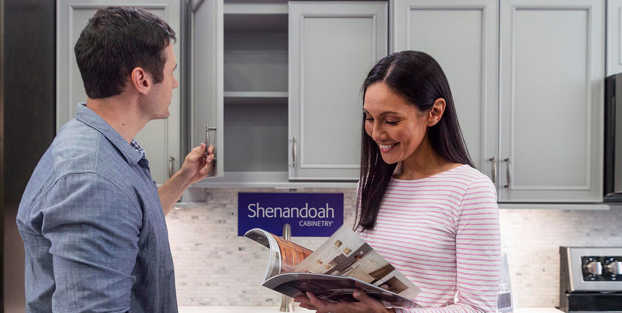 Couple looking at cabinet